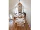 Open living space featuring a stone fireplace, high ceilings, and natural light from large windows at 2970 Chardonnay Ln, Cumming, GA 30041
