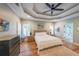 Comfortable main bedroom with a tray ceiling, and abundant natural light at 2970 Chardonnay Ln, Cumming, GA 30041