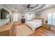 Spacious main bedroom featuring a tray ceiling, hardwood floors, and ample natural light at 2970 Chardonnay Ln, Cumming, GA 30041