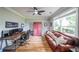 Home office featuring hardwood floors, a large window, and a comfortable leather couch at 2970 Chardonnay Ln, Cumming, GA 30041