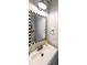 Stylish powder room with a decorative mirror and modern fixtures at 2970 Chardonnay Ln, Cumming, GA 30041