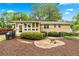Charming backyard with a brick patio, lush landscaping, and an enclosed porch at 322 Emily Drive Sw, Lilburn, GA 30047