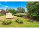 Spacious backyard featuring mature trees, lush landscaping, a shed and a view of the home at 322 Emily Drive Sw, Lilburn, GA 30047