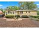 Beautifully landscaped backyard with brick patio, mature trees, and partial privacy fence at 322 Emily Drive Sw, Lilburn, GA 30047