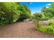 Expansive backyard offering a serene setting with lush greenery, a partial fence and mature trees at 322 Emily Drive Sw, Lilburn, GA 30047