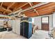 Unfinished basement featuring exposed wood ceiling, concrete floor and access door to the exterior at 322 Emily Drive Sw, Lilburn, GA 30047