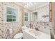 Charming bathroom featuring floral wallpaper, bright natural light, and a large vanity at 322 Emily Drive Sw, Lilburn, GA 30047