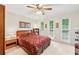 Comfortable bedroom with three windows, ceiling fan, carpet, and traditional furnishings at 322 Emily Drive Sw, Lilburn, GA 30047