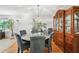 Refined dining room featuring hardwood floors, a large china cabinet, and a round table with seating for six at 322 Emily Drive Sw, Lilburn, GA 30047