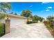 Long driveway leading to an attached garage, surrounded by lush greenery and landscaping at 322 Emily Drive Sw, Lilburn, GA 30047