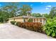 Exterior view of home with lush landscaping, a well-manicured lawn, and an attached garage at 322 Emily Drive Sw, Lilburn, GA 30047