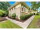 Well-maintained exterior with manicured landscaping, a paved walkway, and mature trees at 322 Emily Drive Sw, Lilburn, GA 30047