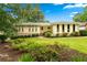 Charming one-story home with manicured lawn and mature landscaping, showcasing a welcoming entrance at 322 Emily Drive Sw, Lilburn, GA 30047