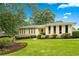 Inviting single-story home featuring well-maintained landscaping and a lush green lawn, offering great curb appeal at 322 Emily Drive Sw, Lilburn, GA 30047