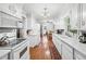 Bright kitchen with modern white cabinets, wood floors, and stainless steel appliances at 322 Emily Drive Sw, Lilburn, GA 30047