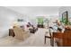 Bright living room with a large window, plush seating, and elegant furnishings, perfect for relaxation and entertaining at 322 Emily Drive Sw, Lilburn, GA 30047