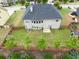 Aerial view of a private backyard, featuring a fence, garden, green lawn, and shade trees at 3631 Guinevere Trace Trce, Douglasville, GA 30135
