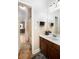 An ensuite bathroom featuring a mirror, vanity, toilet, and shower-tub combo in view of the bedroom at 3631 Guinevere Trace Trce, Douglasville, GA 30135