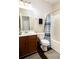 A standard bathroom featuring a shower-tub combo, toilet, vanity, mirror, and decorative floor mat at 3631 Guinevere Trace Trce, Douglasville, GA 30135