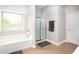 Clean bathroom featuring ceramic tile floors, a white shower, and a window letting in natural light at 3631 Guinevere Trace Trce, Douglasville, GA 30135