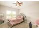 Cozy bedroom featuring a soft color palette, plush bedding, carpet, and a bright window view at 3631 Guinevere Trace Trce, Douglasville, GA 30135