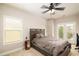 A well-lit bedroom with carpet floors, ceiling fan, a cozy bed, and an outdoor balcony at 3631 Guinevere Trace Trce, Douglasville, GA 30135