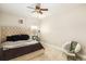 Cozy bedroom featuring neutral walls, a comfortable upholstered bed, a ceiling fan and soft carpet flooring at 3631 Guinevere Trace Trce, Douglasville, GA 30135
