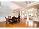 Spacious dining room with wood floors and a decorative chandelier; open view to the living room at 3631 Guinevere Trace Trce, Douglasville, GA 30135