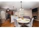 Eat-in kitchen features stainless steel appliances, pendant lighting and a stone fireplace at 3631 Guinevere Trace Trce, Douglasville, GA 30135