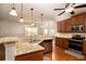 Kitchen with granite countertops, stainless steel appliances, wood cabinets, and pendant lights at 3631 Guinevere Trace Trce, Douglasville, GA 30135
