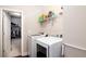 A functional laundry room equipped with modern washer, dryer, and overhead storage shelves at 3631 Guinevere Trace Trce, Douglasville, GA 30135