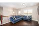 Upstairs living room with a large blue sectional sofa, hardwood floors, and ample natural light from the windows at 3631 Guinevere Trace Trce, Douglasville, GA 30135