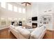 Bright living room with fireplace, built-in shelving, lots of natural light, and wood flooring at 3631 Guinevere Trace Trce, Douglasville, GA 30135