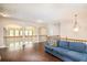 Upstairs living room with hardwood floors, a blue sofa, and decorative railing with arched window views at 3631 Guinevere Trace Trce, Douglasville, GA 30135