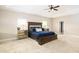 Spacious main bedroom with a tray ceiling, neutral carpet, and ample natural light from two windows at 3631 Guinevere Trace Trce, Douglasville, GA 30135