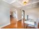 Home office with wood floors, coffered ceiling, and an arched entryway to another room at 3631 Guinevere Trace Trce, Douglasville, GA 30135