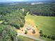 Drone shot of a home nestled among forests and farmland at 668 Spring Place Ne Rd, White, GA 30184