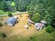 Bird's eye view of the property featuring the home, outbuildings, and vast landscape including a wooded backdrop at 668 Spring Place Ne Rd, White, GA 30184