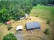 Aerial view of the house and its various outbuildings and expansive wooded areas at 668 Spring Place Ne Rd, White, GA 30184