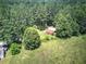 Elevated perspective of outbuilding surrounded by tall trees and open land showing a countryside estate at 668 Spring Place Ne Rd, White, GA 30184