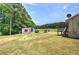 Expansive backyard with outbuildings and ample green space at 668 Spring Place Ne Rd, White, GA 30184