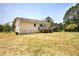 Large backyard with mature trees, storage space, and covered deck at 668 Spring Place Ne Rd, White, GA 30184