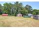 A backyard with multiple outbuildings, including sheds and storage units at 668 Spring Place Ne Rd, White, GA 30184