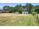 Large backyard featuring diverse storage buildings, and well-tended lawn at 668 Spring Place Ne Rd, White, GA 30184