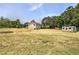 Expansive backyard featuring a storage building and a well-maintained lawn at 668 Spring Place Ne Rd, White, GA 30184