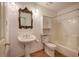 Bright bathroom featuring pedestal sink and tub with shower at 668 Spring Place Ne Rd, White, GA 30184