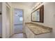 Bathroom vanity with a granite countertop, updated fixtures, and adjacent bedroom access at 668 Spring Place Ne Rd, White, GA 30184