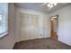 Bedroom with neutral walls and closet at 668 Spring Place Ne Rd, White, GA 30184
