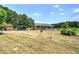 Exterior showcasing car port, storage buildings, and an expansive yard at 668 Spring Place Ne Rd, White, GA 30184