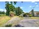 Exterior view of home with car port, storage buildings, and well-maintained landscape at 668 Spring Place Ne Rd, White, GA 30184